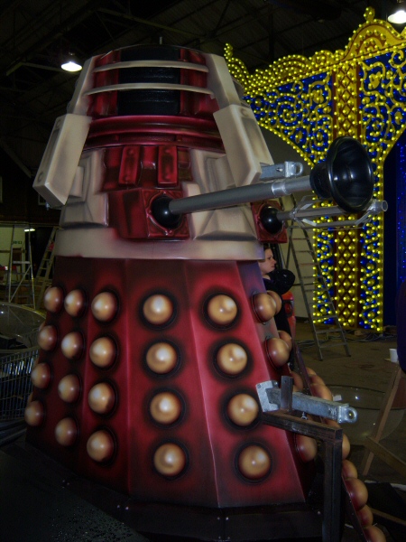 Photo - Red Dalek (1 of 1) - Red Dalek in the depot with the Rangoli Peacock feature in the background - Dr Who Davros 2009 - Blackpool Illuminations Gallery - © Sarah Myerscough